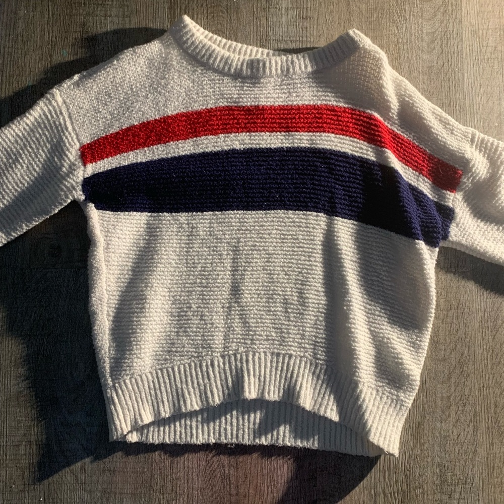 White pull over with red, blue and white stripe